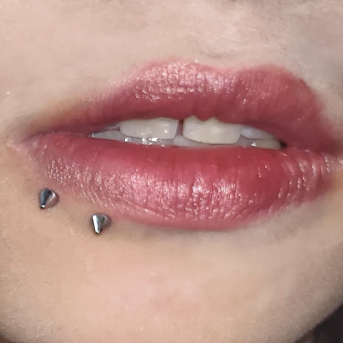 Pointed labret stud lip piercing jewelry detail